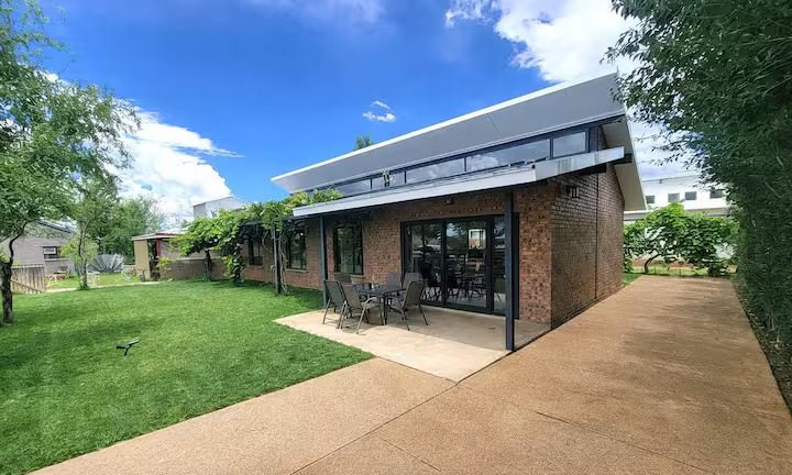 Exterior of the Wilger Rus Orania Vacation Home with its lawn and paved walkway